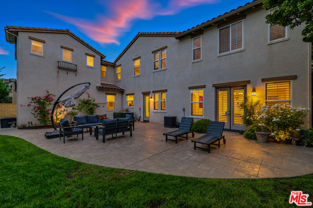 22074 Sagebrook Road Chatsworth, CA 91311 - Photo 33 of 35 a view of a patio with table and chairs potted plants and a bench
