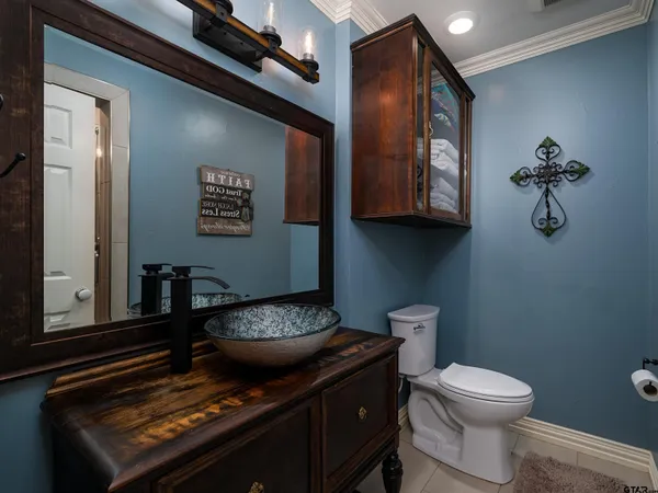 a bathroom with a toilet a sink and mirror