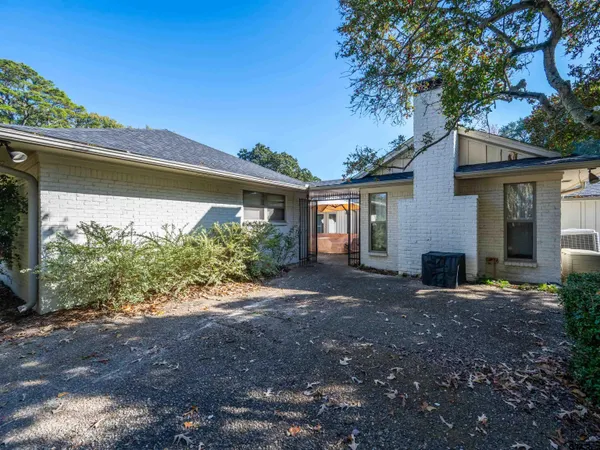 a view of a house with yard and a tree