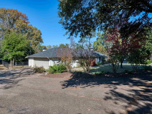 a view of a house with a tree in the background