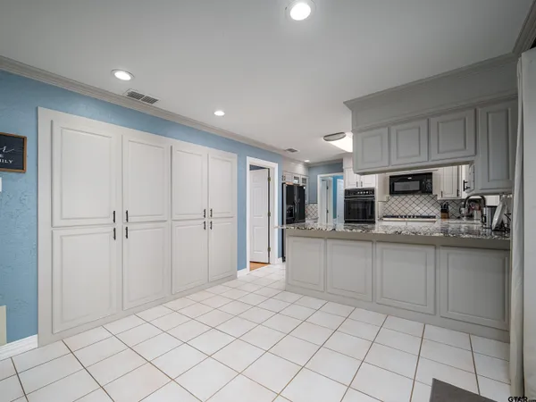 a kitchen with stainless steel appliances granite countertop a refrigerator and a sink