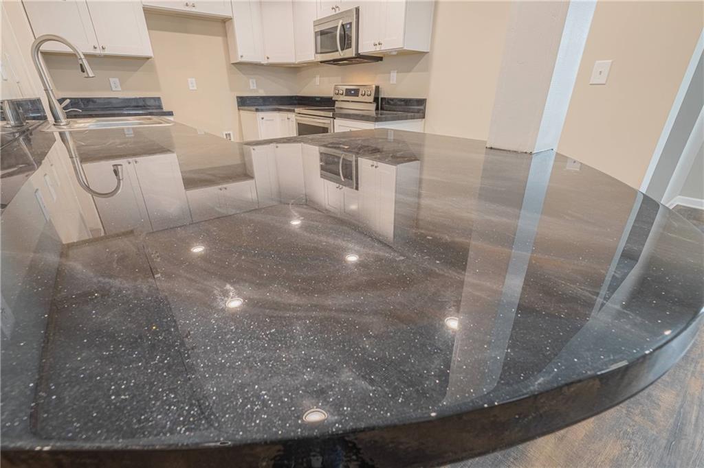 3107 Hendrix Circle Southwest Covington, GA 30014 - Photo 23 of 66 a kitchen with white cabinets and stainless steel appliances