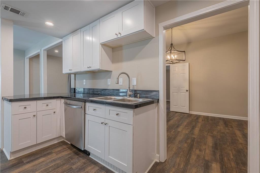 3107 Hendrix Circle Southwest Covington, GA 30014 - Photo 26 of 66 a kitchen with granite countertop a sink cabinets and wooden floor