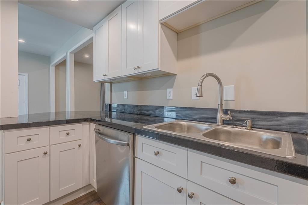 3107 Hendrix Circle Southwest Covington, GA 30014 - Photo 31 of 66 a kitchen with granite countertop white cabinets and sink