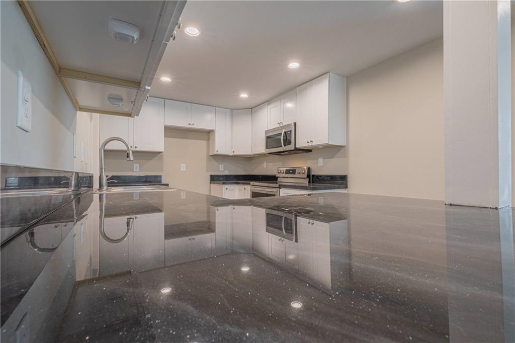 3107 Hendrix Circle Southwest Covington, GA 30014 - Photo 36 of 66 a kitchen with a sink cabinets and stainless steel appliances