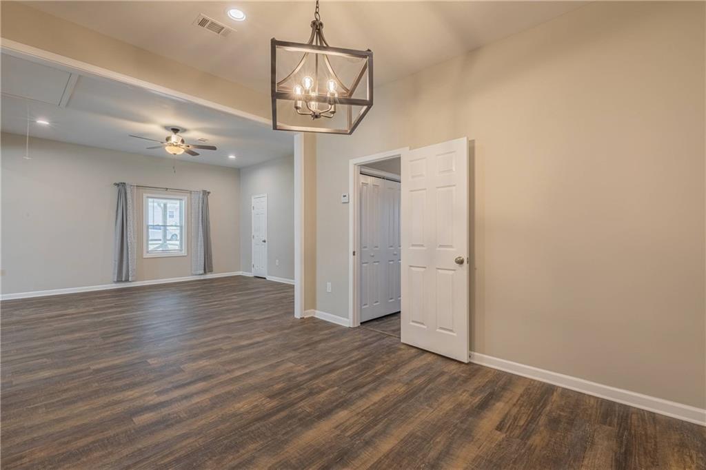 3107 Hendrix Circle Southwest Covington, GA 30014 - Photo 38 of 66 an empty room with wooden floor and windows
