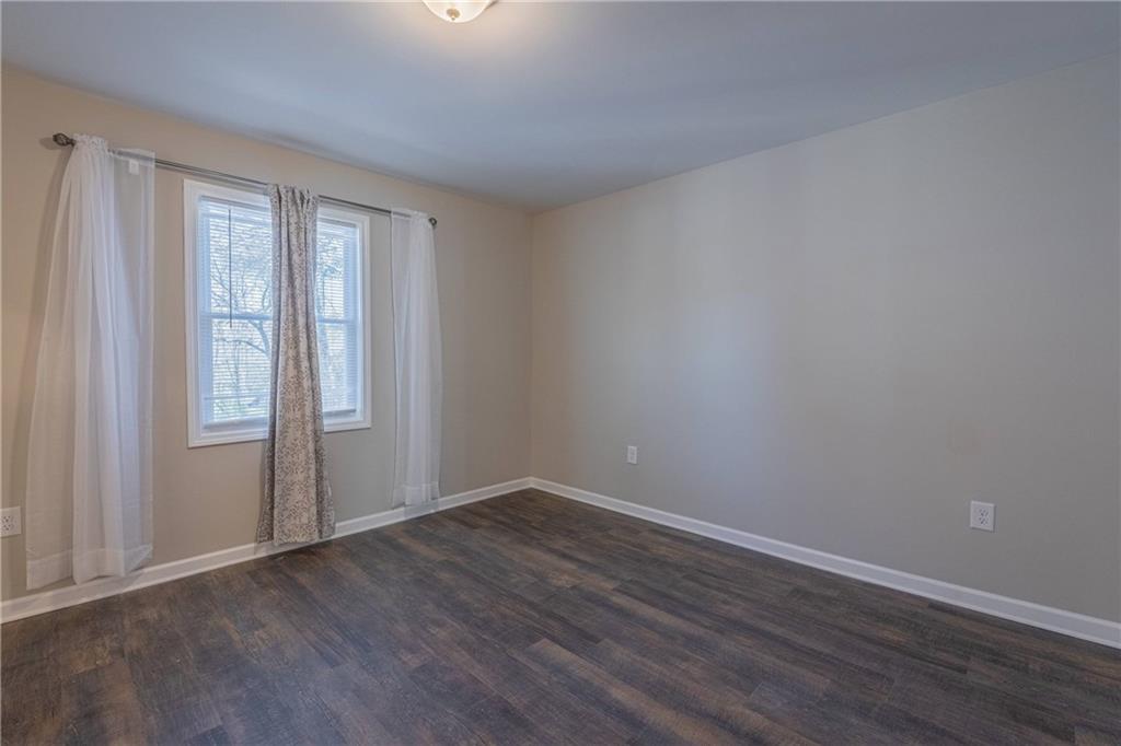 3107 Hendrix Circle Southwest Covington, GA 30014 - Photo 39 of 66 a view of an empty room with wooden floor and a window