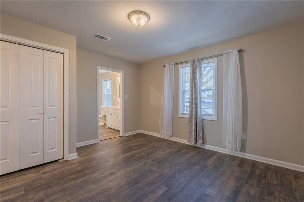 3107 Hendrix Circle Southwest Covington, GA 30014 - Photo 40 of 66 an empty room with wooden floor and windows