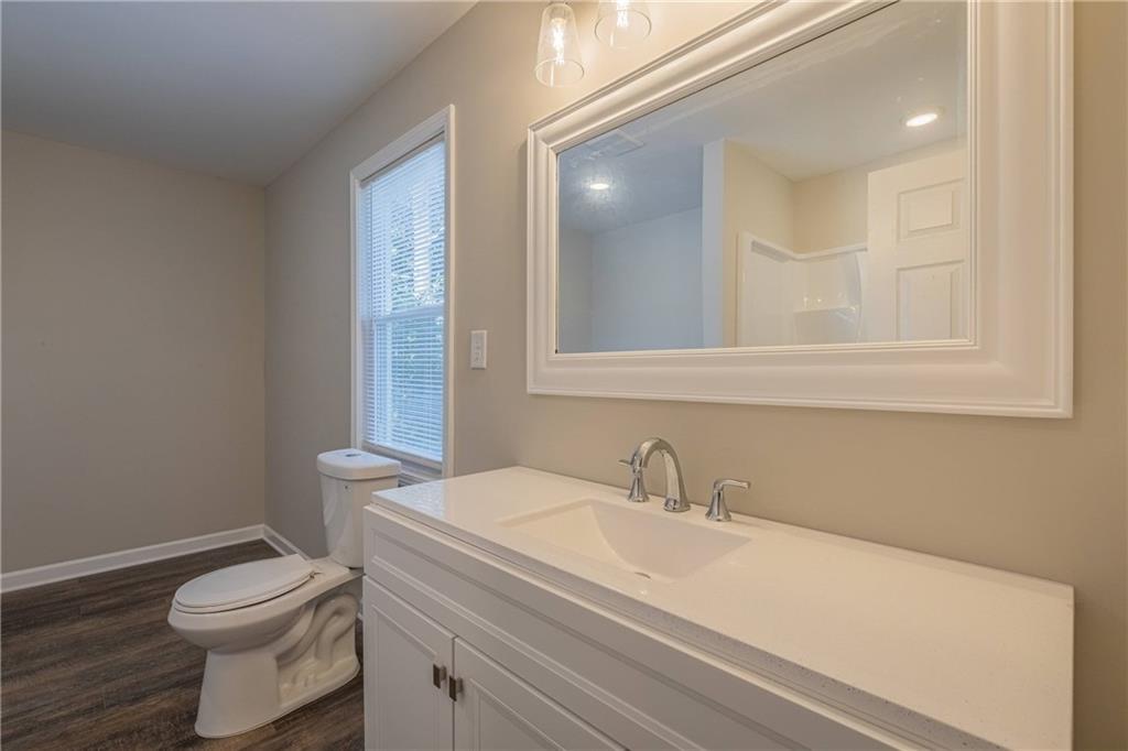 3107 Hendrix Circle Southwest Covington, GA 30014 - Photo 44 of 66 a bathroom with a sink a toilet and mirror