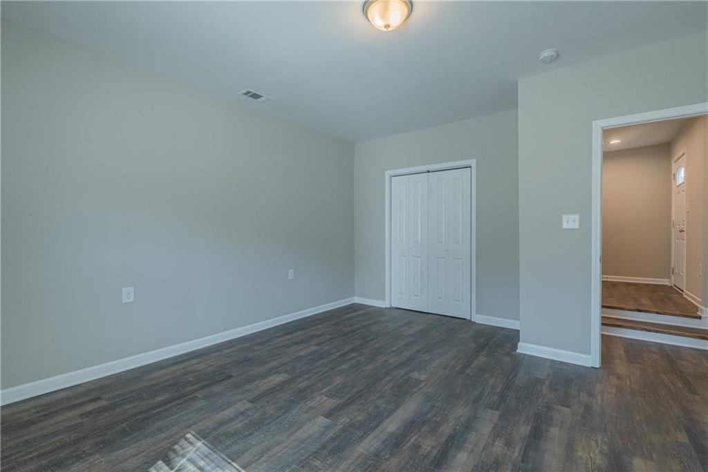 3107 Hendrix Circle Southwest Covington, GA 30014 - Photo 50 of 66 a view of an empty room with wooden floor and a window