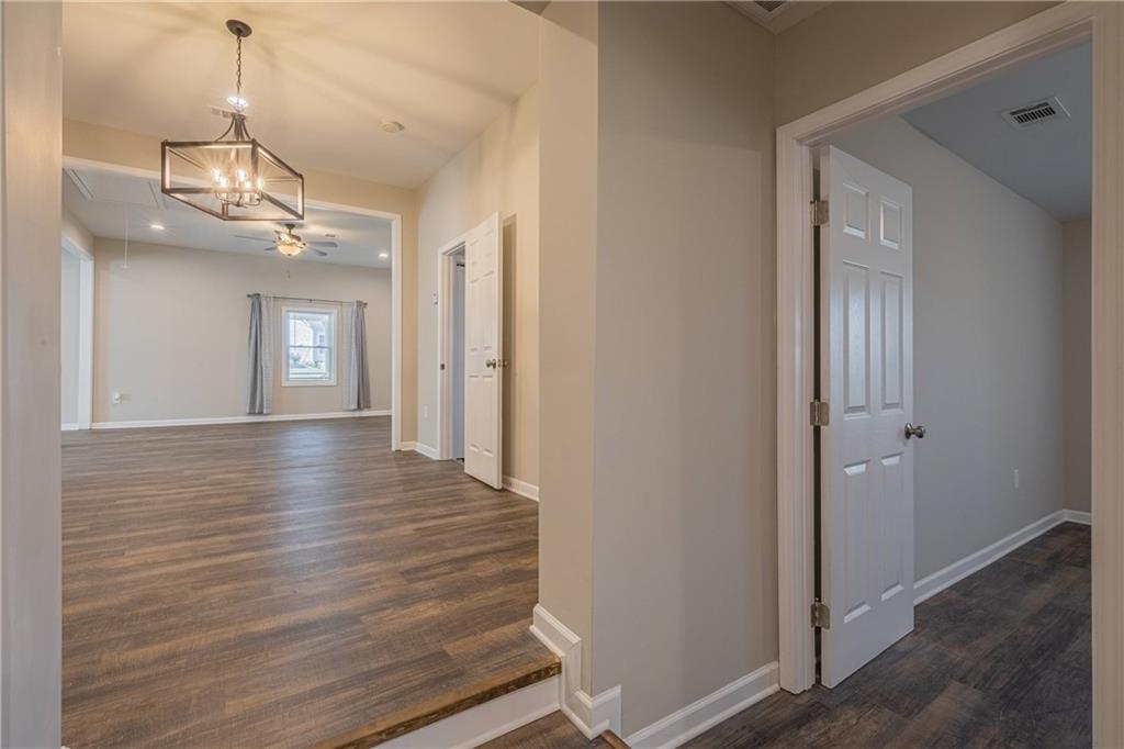 3107 Hendrix Circle Southwest Covington, GA 30014 - Photo 51 of 66 a view of a hallway with wooden floor and staircase