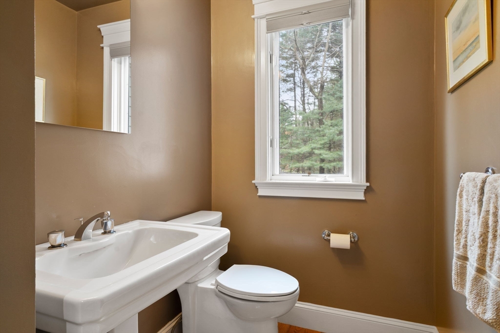 5 Powisset Street Dover, MA 02030 - Photo 19 of 41 a bathroom with a sink a toilet and a window