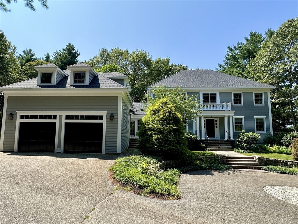 5 Powisset Street Dover, MA 02030 - Photo 2 of 41 a front view of a house with a yard and garage