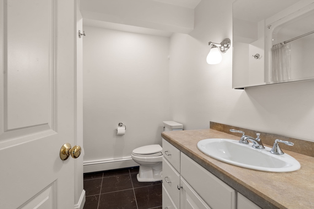 5 Powisset Street Dover, MA 02030 - Photo 31 of 41 a bathroom with a granite countertop sink toilet and a mirror