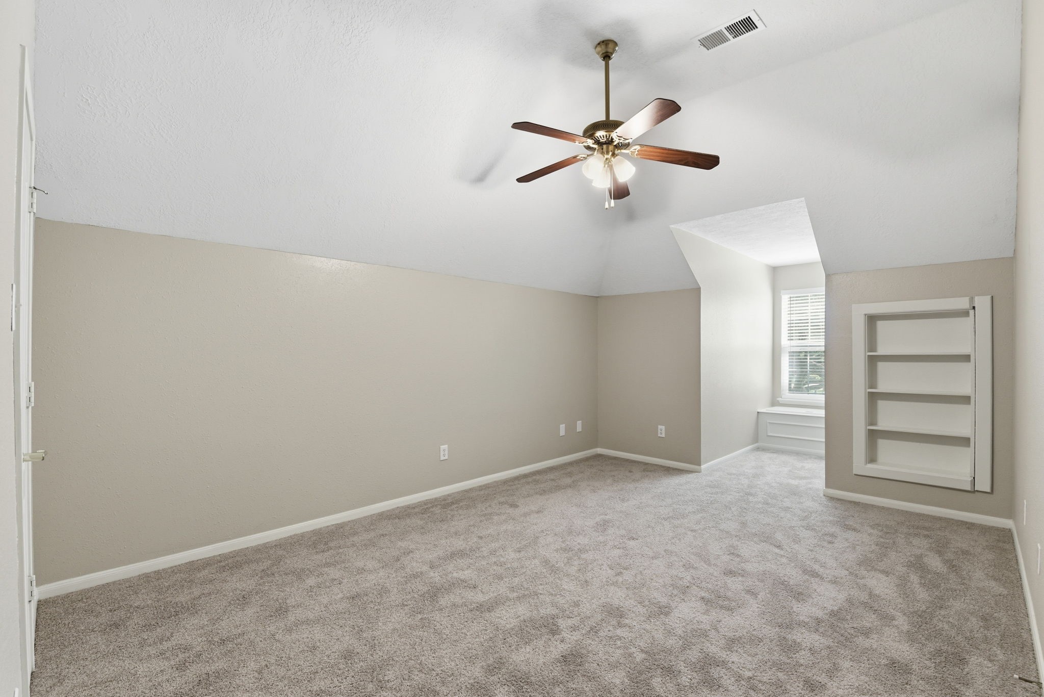 3414 Hackberry Court Spring, TX 77388 - Photo 41 of 50 This is the other secondary bedroom that shares the Jack and Jill bathroom. It also has the built in storage in the dormer window area, fresh paint, ceiling fan and carpet replaced in April 2026. But it also has a hidden feature!