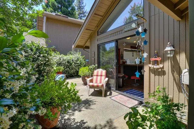 a view of a patio with table and chairs and potted plants