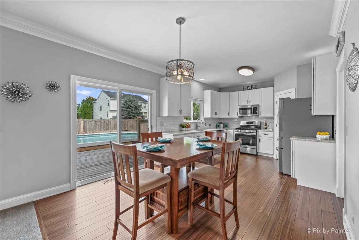 313 Market Street Genoa, IL 60135 - Photo 15 of 49 a view of a dining room with furniture large window and wooden floor