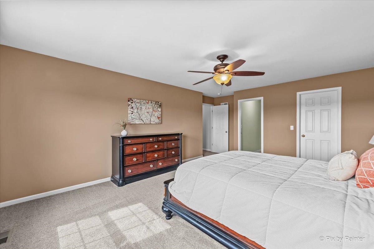 313 Market Street Genoa, IL 60135 - Photo 20 of 49 a bedroom with a bed and a chandelier