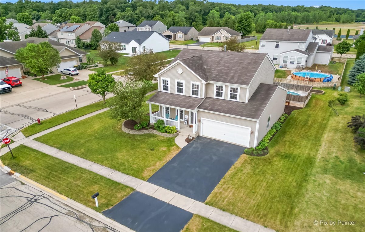313 Market Street Genoa, IL 60135 - Photo 2 of 49 an aerial view of residential houses with outdoor space and trees