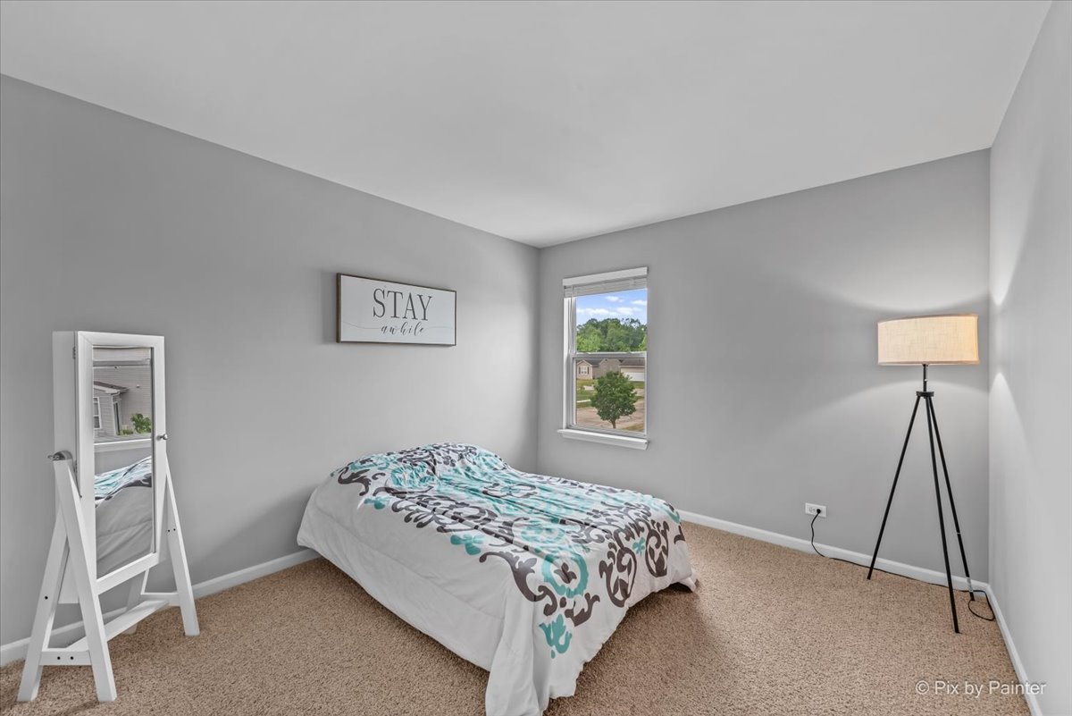 313 Market Street Genoa, IL 60135 - Photo 24 of 49 a bedroom with a bed and a window