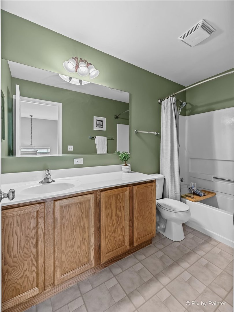 313 Market Street Genoa, IL 60135 - Photo 27 of 49 a bathroom with a double vanity sink and a mirror