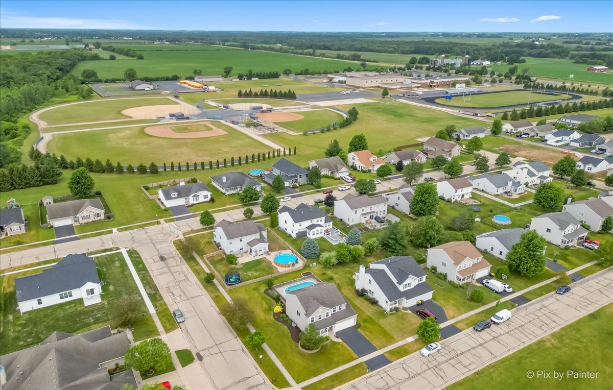 313 Market Street Genoa, IL 60135 - Photo 34 of 49 a view of swimming pool with a lot of trees and houses