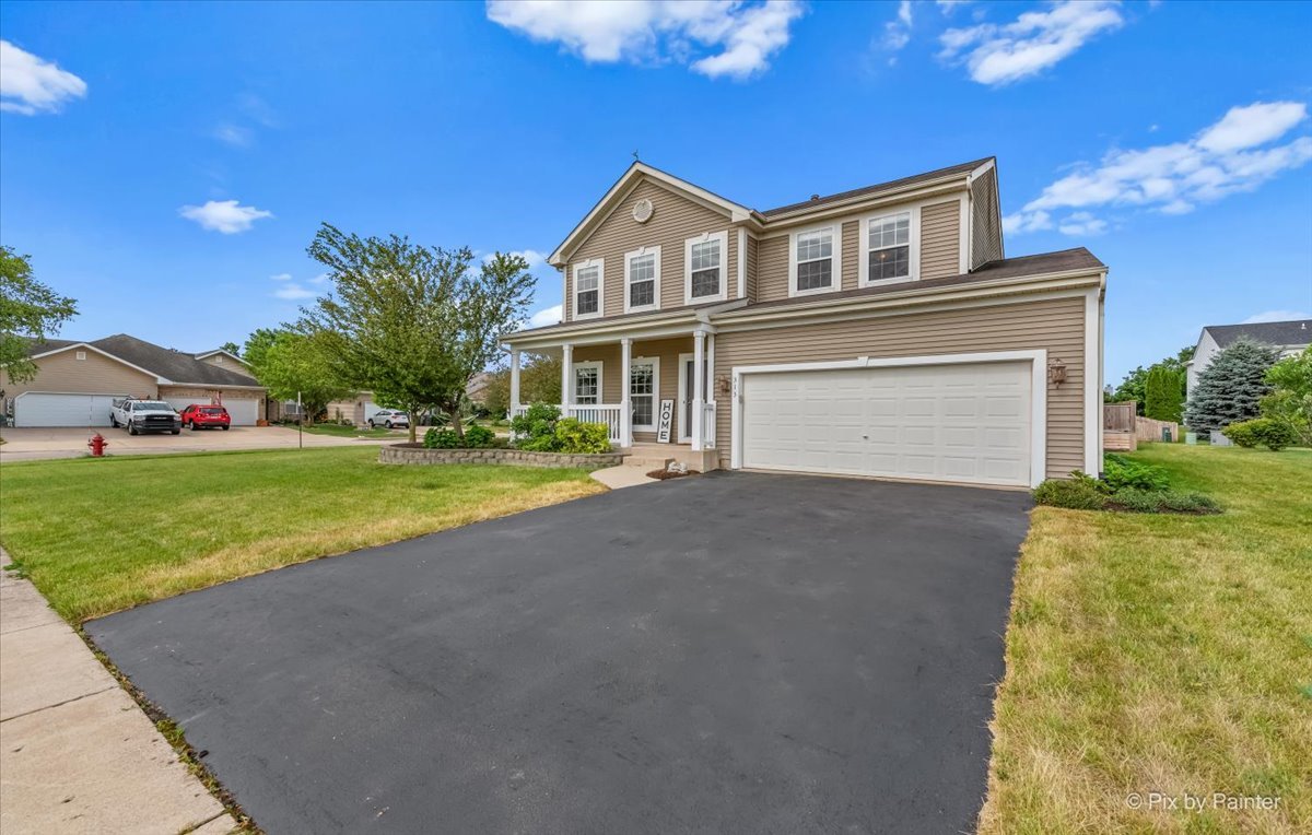 313 Market Street Genoa, IL 60135 - Photo 47 of 49 a front view of house with yard and green space