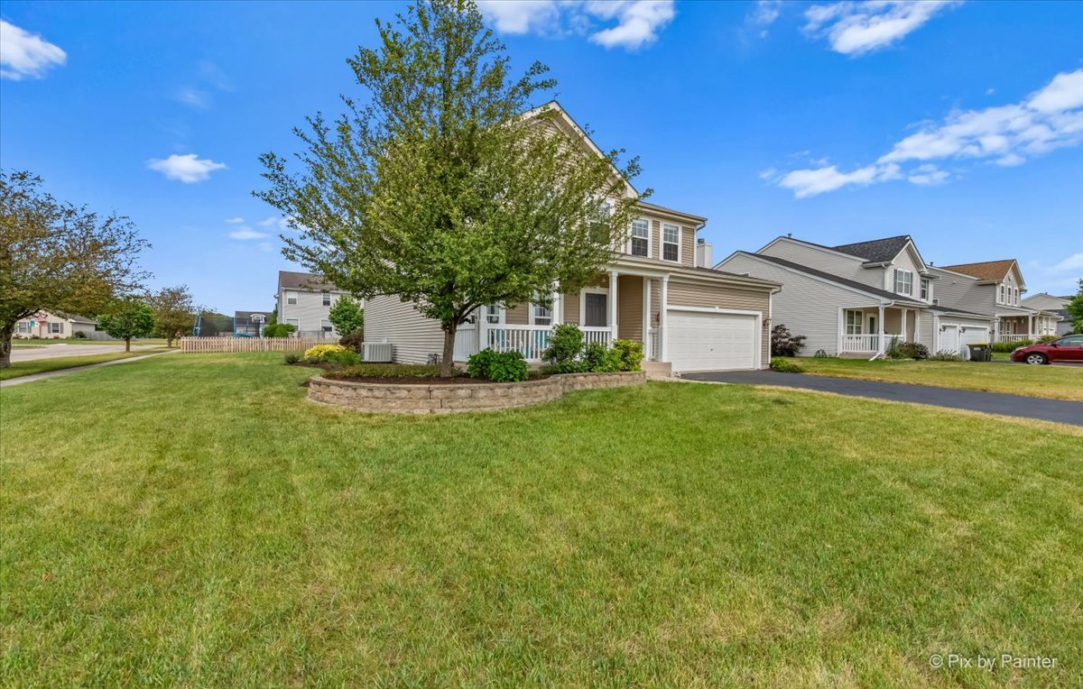 313 Market Street Genoa, IL 60135 - Photo 48 of 49 a front view of a house with a garden