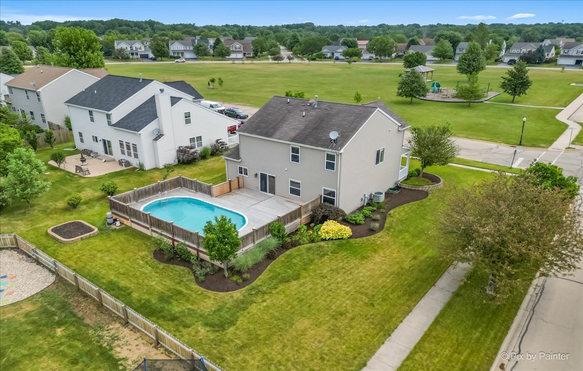 313 Market Street Genoa, IL 60135 - Photo 5 of 49 an aerial view of a house with pool and a yard