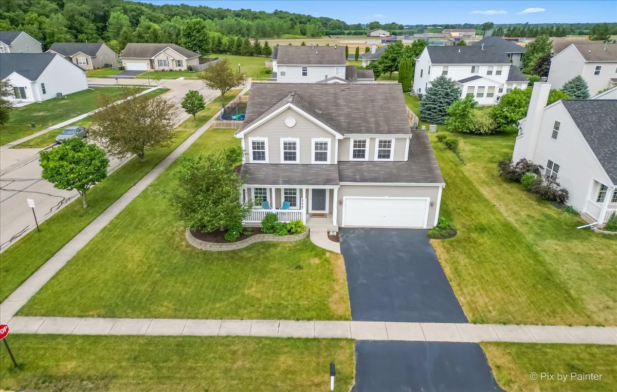 313 Market Street Genoa, IL 60135 - Photo 6 of 49 an aerial view of residential houses with outdoor space and swimming pool