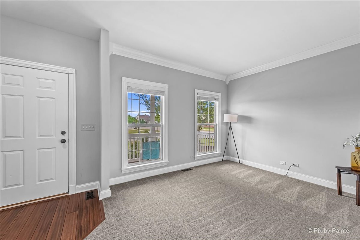 313 Market Street Genoa, IL 60135 - Photo 9 of 49 an empty room with windows