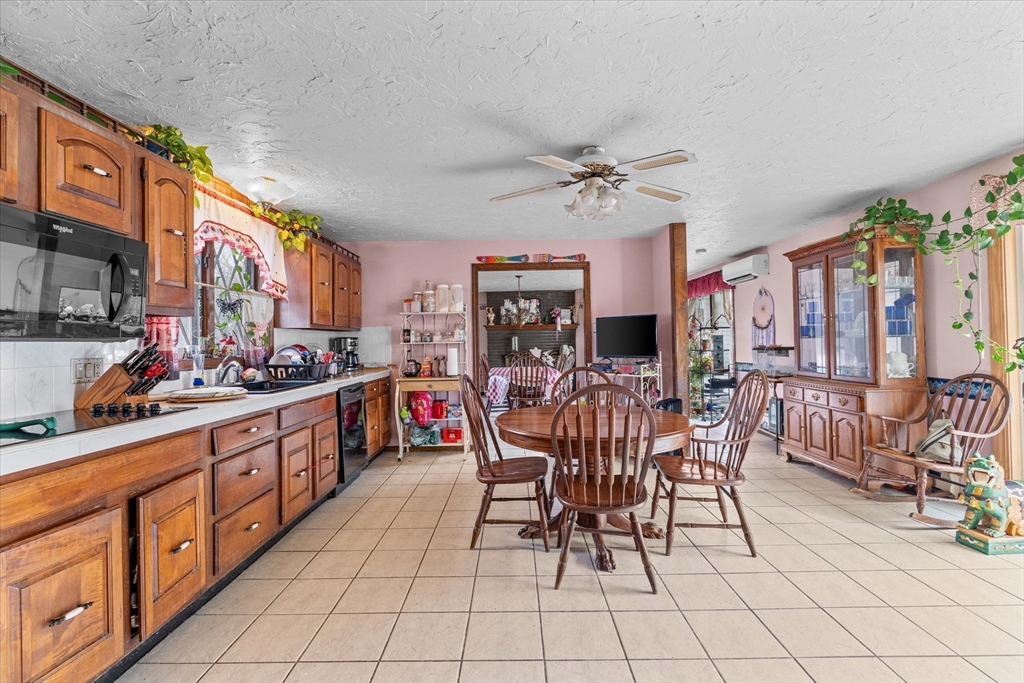 186 8 Lots Road Sutton, MA 01590 - Photo 9 of 33 a view of a dining room with furniture window and wooden floor