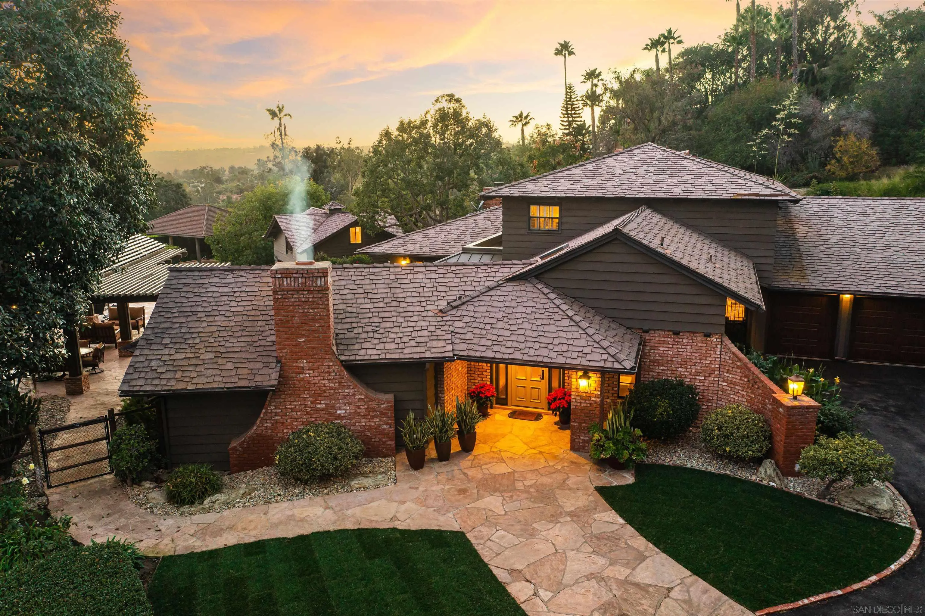a view of a house with a sink and outdoor kitchen