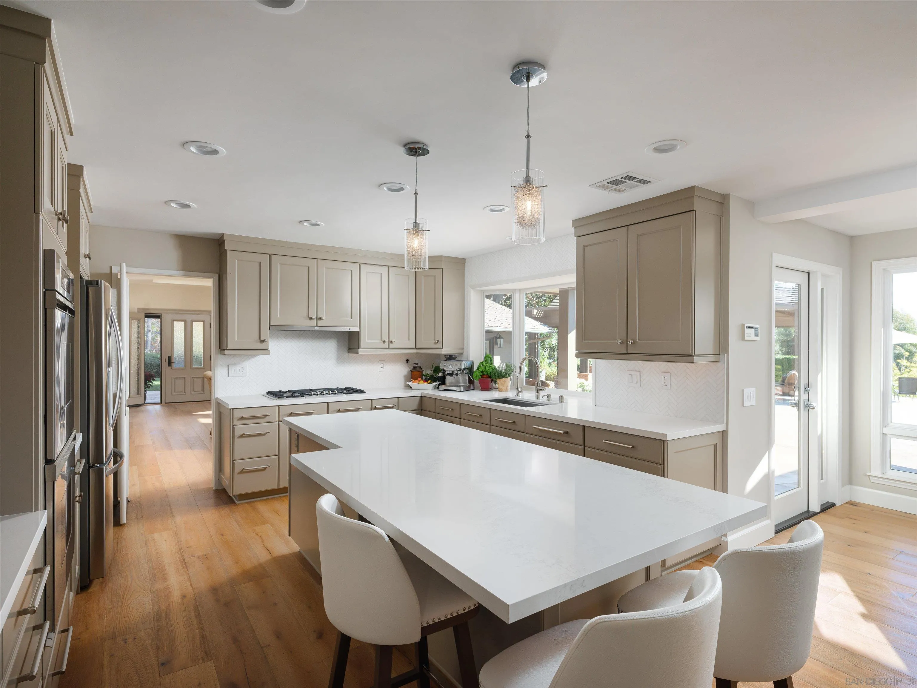 17136 El Mirador Rancho Santa Fe, CA 92067 - Photo 22 of 58 a large kitchen with cabinets table and chairs