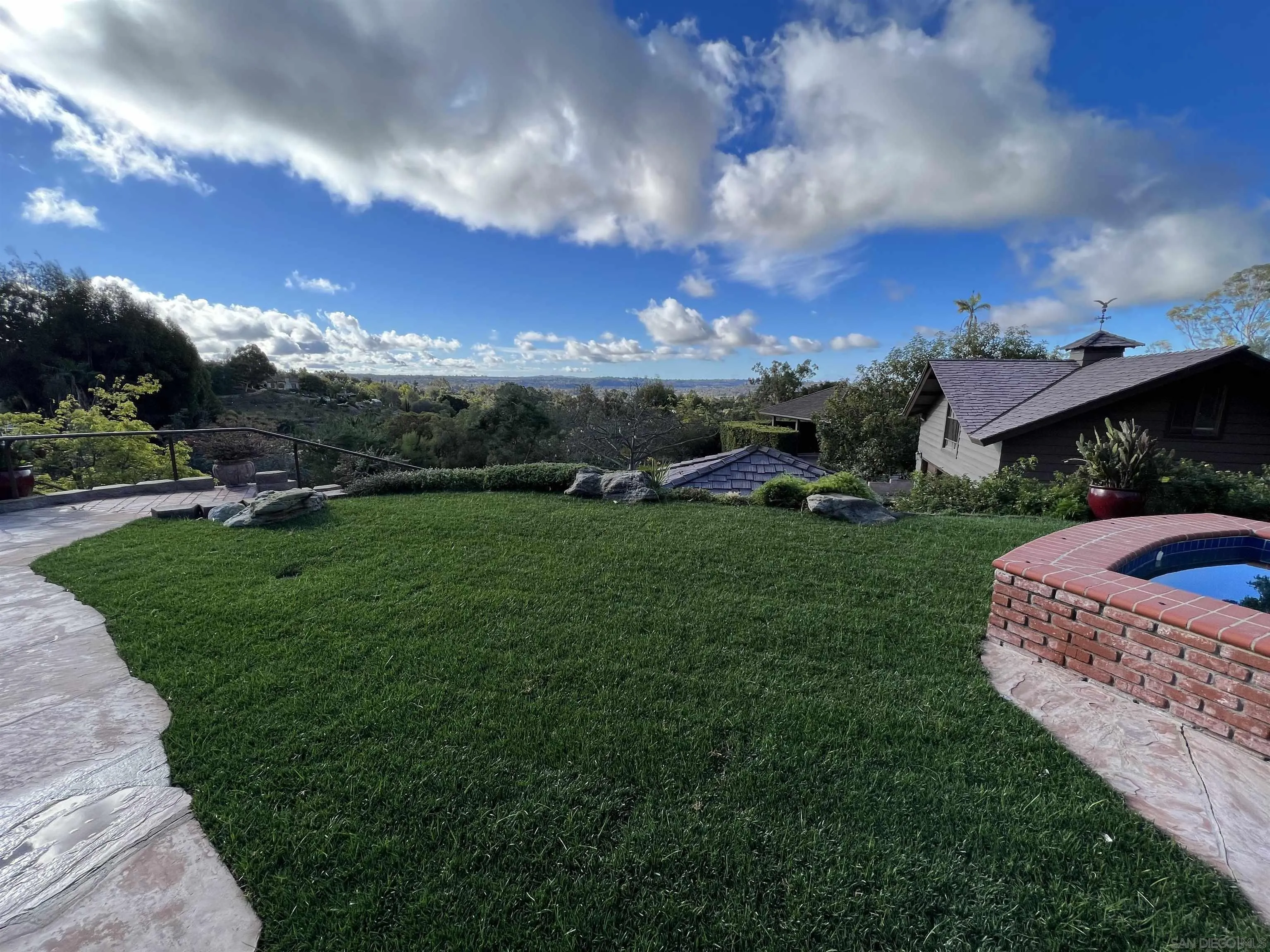 17136 El Mirador Rancho Santa Fe, CA 92067 - Photo 4 of 58 a view of a big house with a big yard and large trees