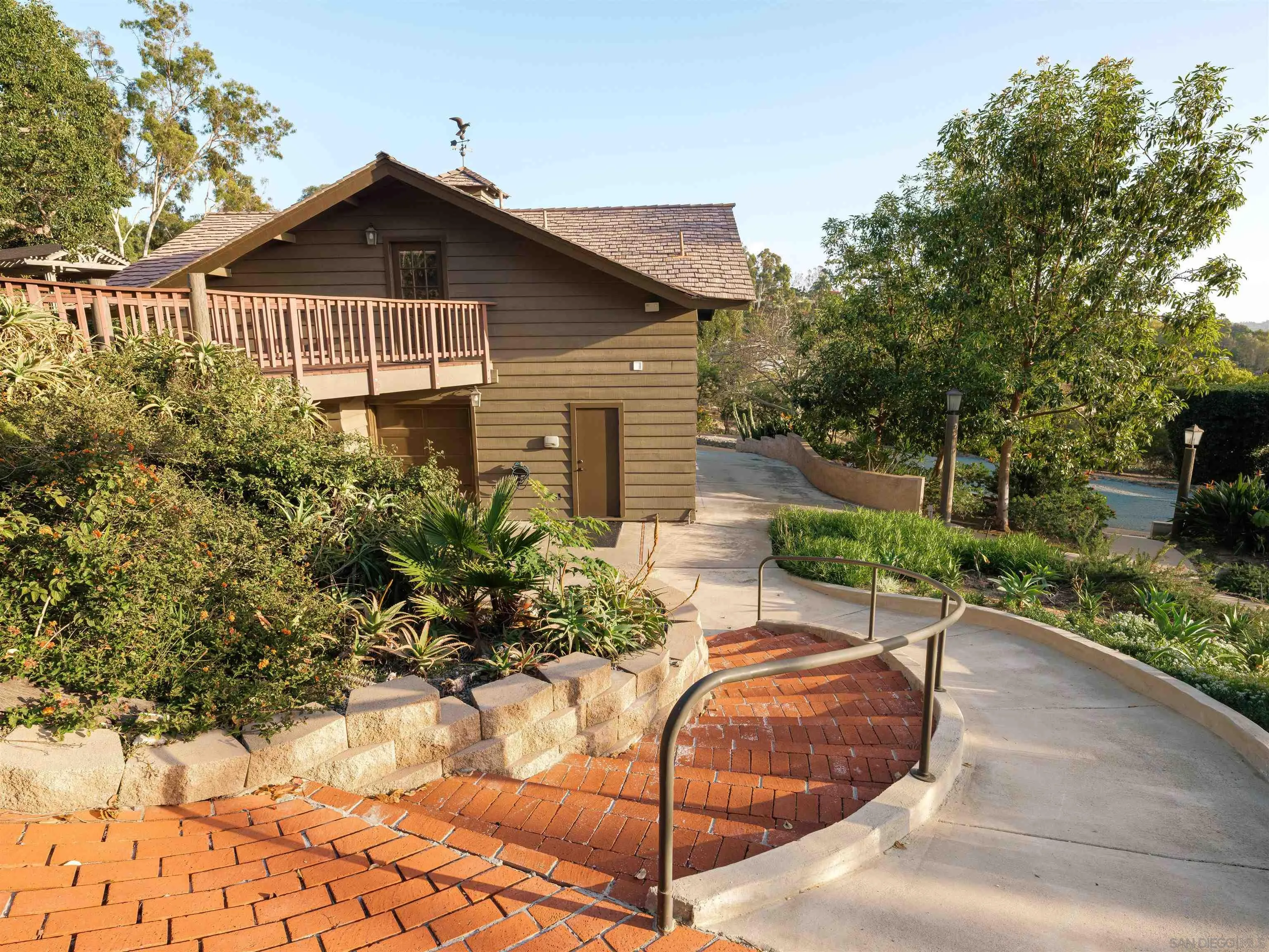 17136 El Mirador Rancho Santa Fe, CA 92067 - Photo 6 of 58 a front view of a house with a yard