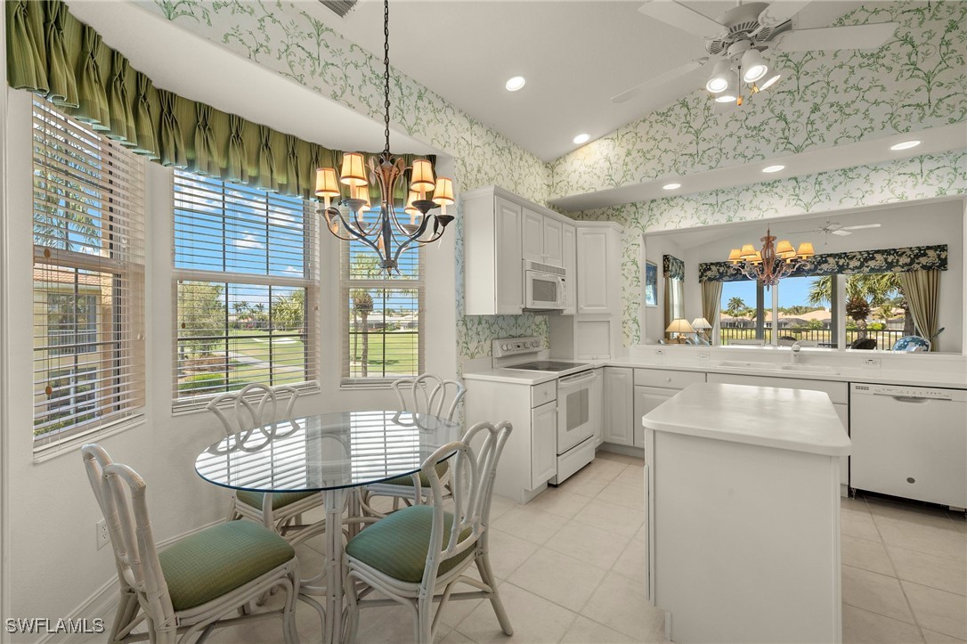 a kitchen with kitchen island granite countertop a table and chairs in it