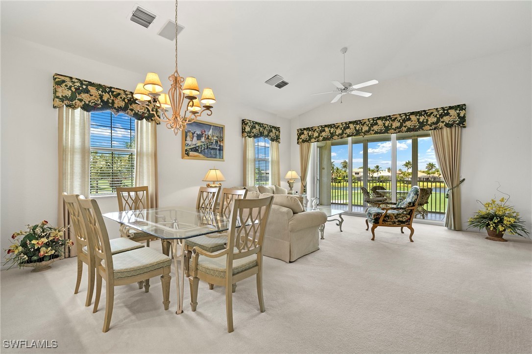 6035 Trophy Drive, Unit 103 Naples, FL 34110 - Photo 12 of 44 a dining room with furniture a chandelier and window