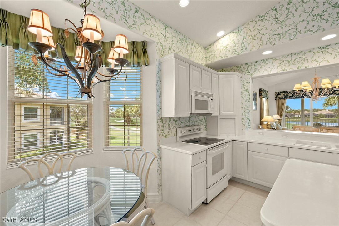 6035 Trophy Drive, Unit 103 Naples, FL 34110 - Photo 16 of 44 a kitchen that has a sink and a chair in it