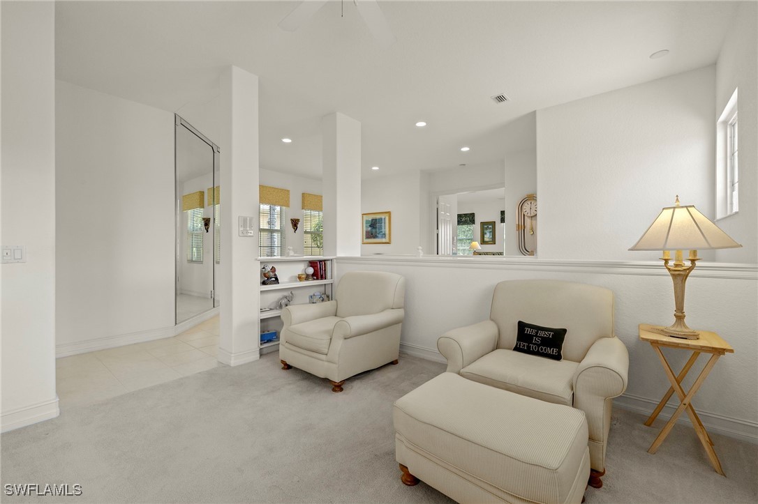 6035 Trophy Drive, Unit 103 Naples, FL 34110 - Photo 17 of 44 a living room with furniture and a lamp