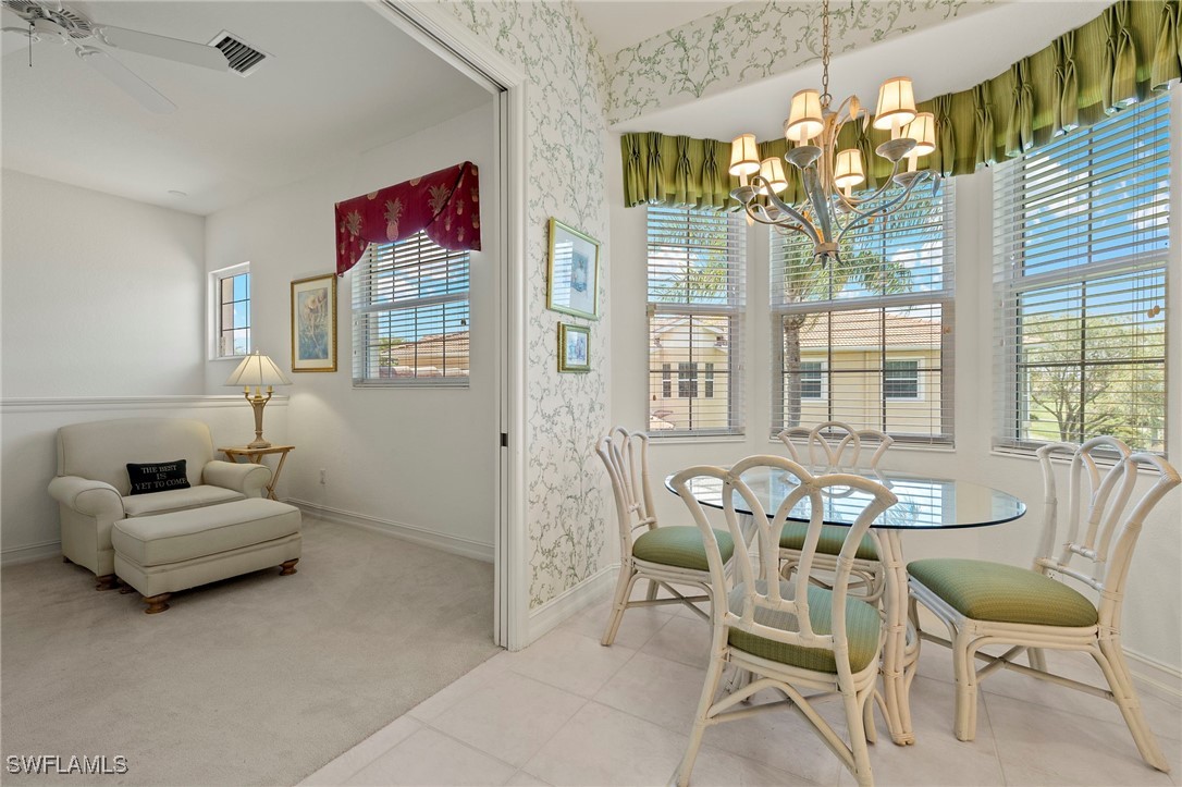 6035 Trophy Drive, Unit 103 Naples, FL 34110 - Photo 19 of 44 a living room with furniture and a floor to ceiling window
