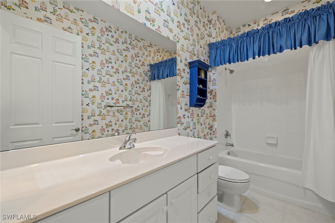 6035 Trophy Drive, Unit 103 Naples, FL 34110 - Photo 30 of 44 a bathroom with a sink a toilet and shower