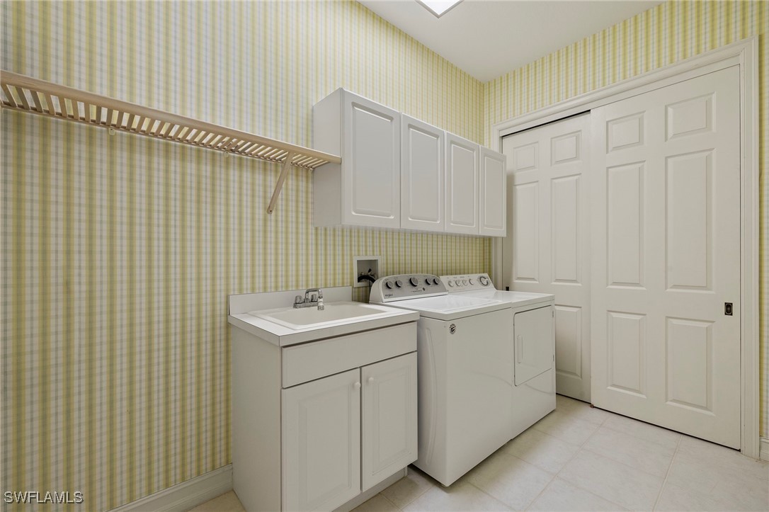 6035 Trophy Drive, Unit 103 Naples, FL 34110 - Photo 31 of 44 a utility room with dryer and washer