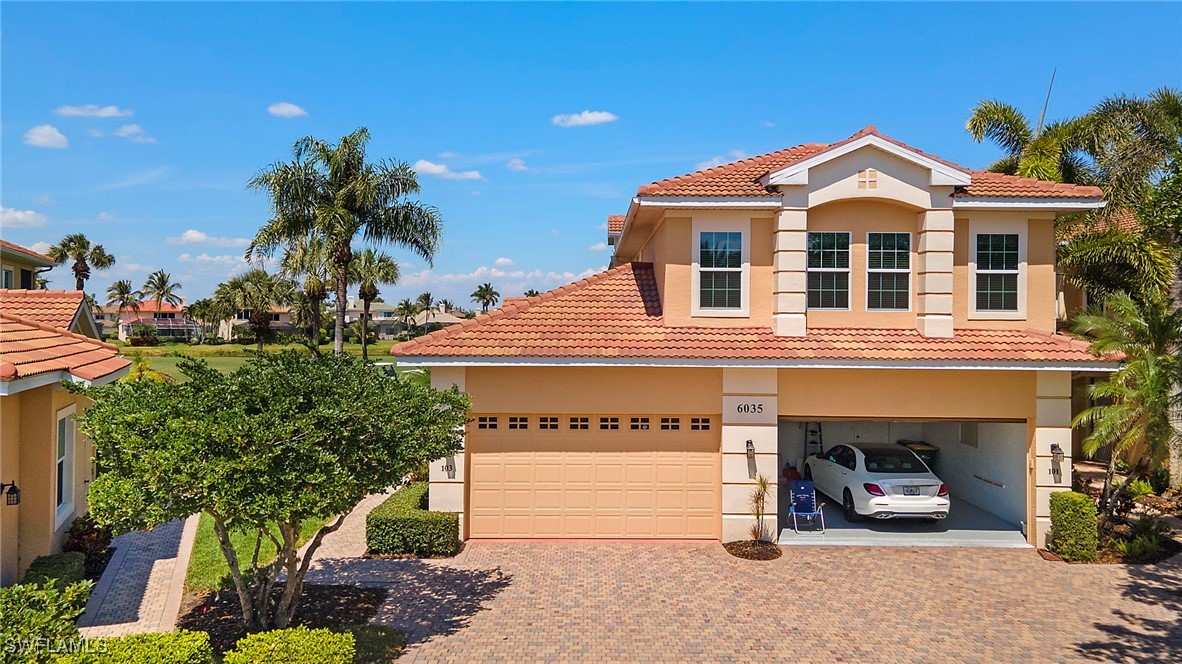 6035 Trophy Drive, Unit 103 Naples, FL 34110 - Photo 34 of 44 a front view of a building with garden