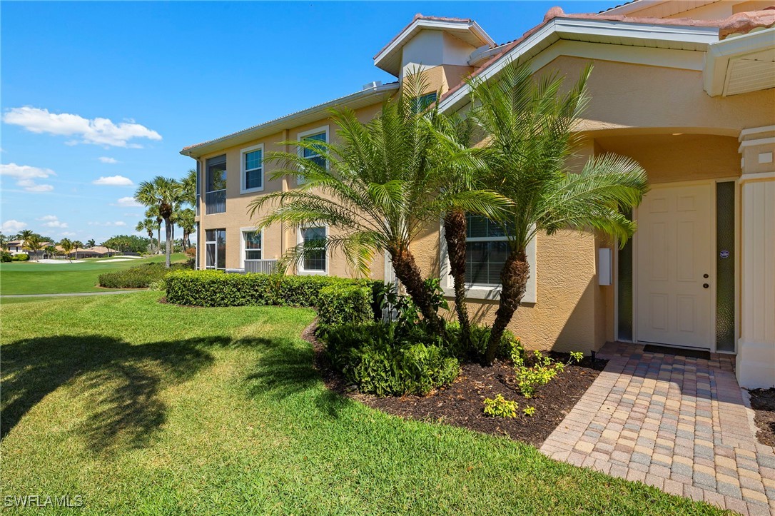 6035 Trophy Drive, Unit 103 Naples, FL 34110 - Photo 5 of 44 a front view of a house with garden
