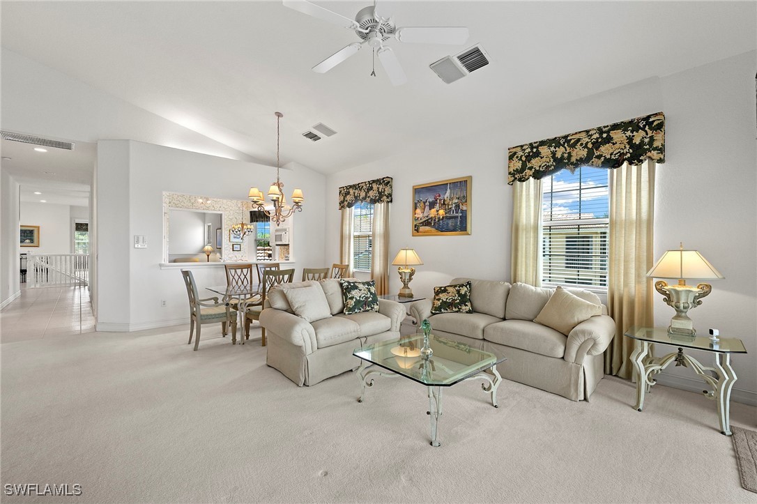 6035 Trophy Drive, Unit 103 Naples, FL 34110 - Photo 10 of 44 a living room with furniture and a large window