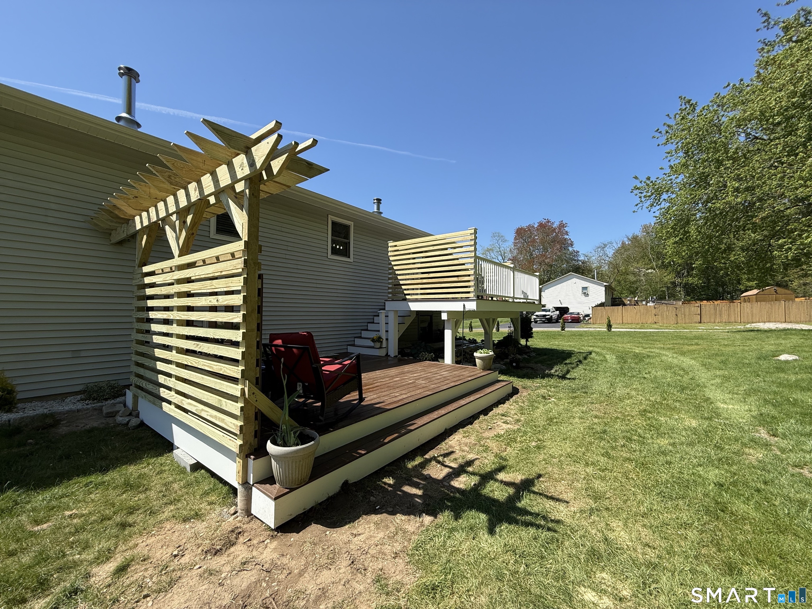 29 Deer Ridge Road Stonington, CT 06378 - Photo 33 of 35 a view of a backyard with chairs and a small yard