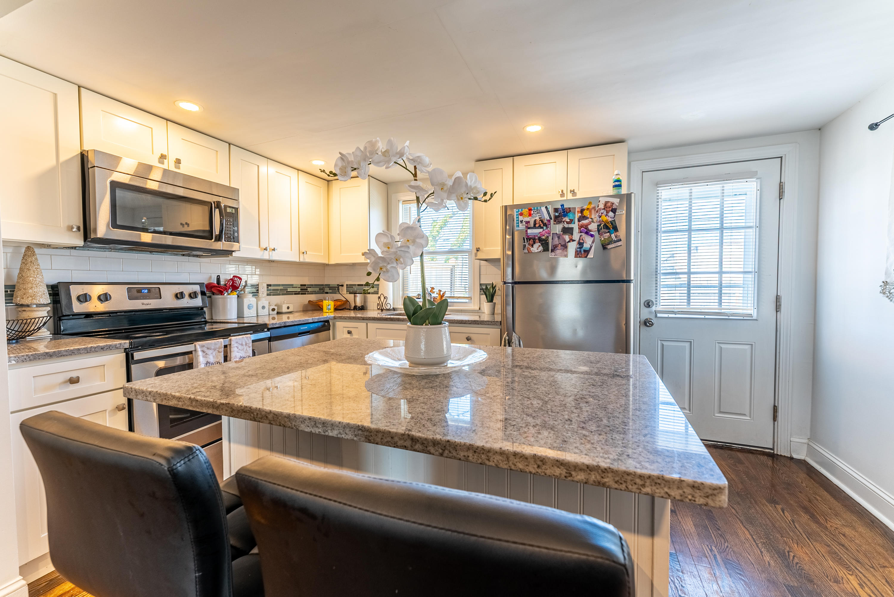 15 Brookshire Road Hyannis, MA 02601 - Photo 11 of 33 a kitchen with stainless steel appliances granite countertop a refrigerator a stove top oven a sink dishwasher and white cabinets with wooden floor