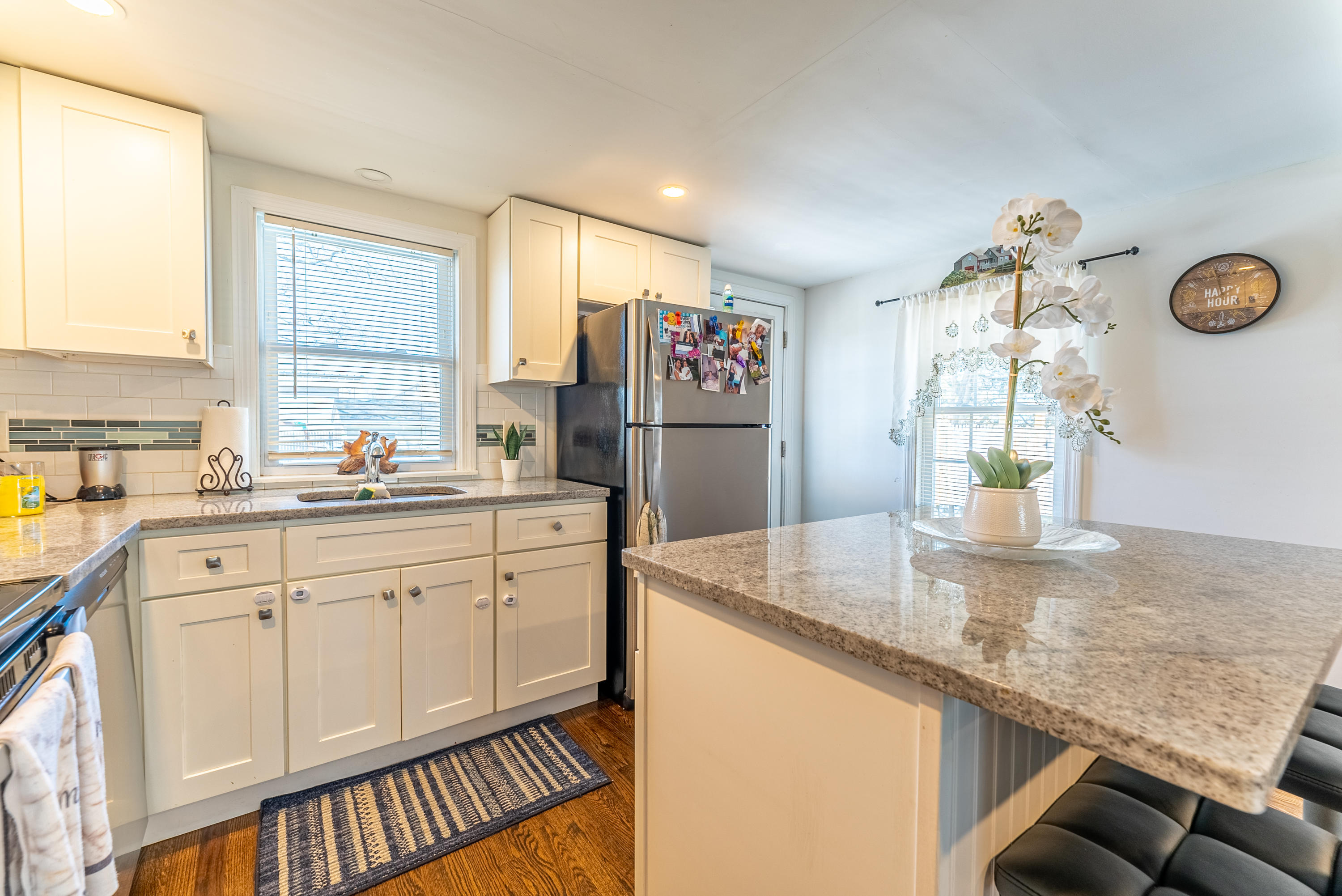 15 Brookshire Road Hyannis, MA 02601 - Photo 14 of 33 a kitchen with stainless steel appliances granite countertop a sink dishwasher and a refrigerator with wooden floor