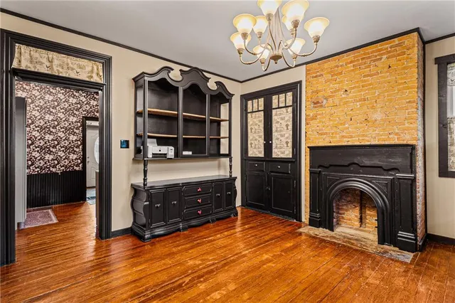 a kitchen with stainless steel appliances granite countertop a refrigerator a sink dishwasher a stove and white countertops with wooden floor